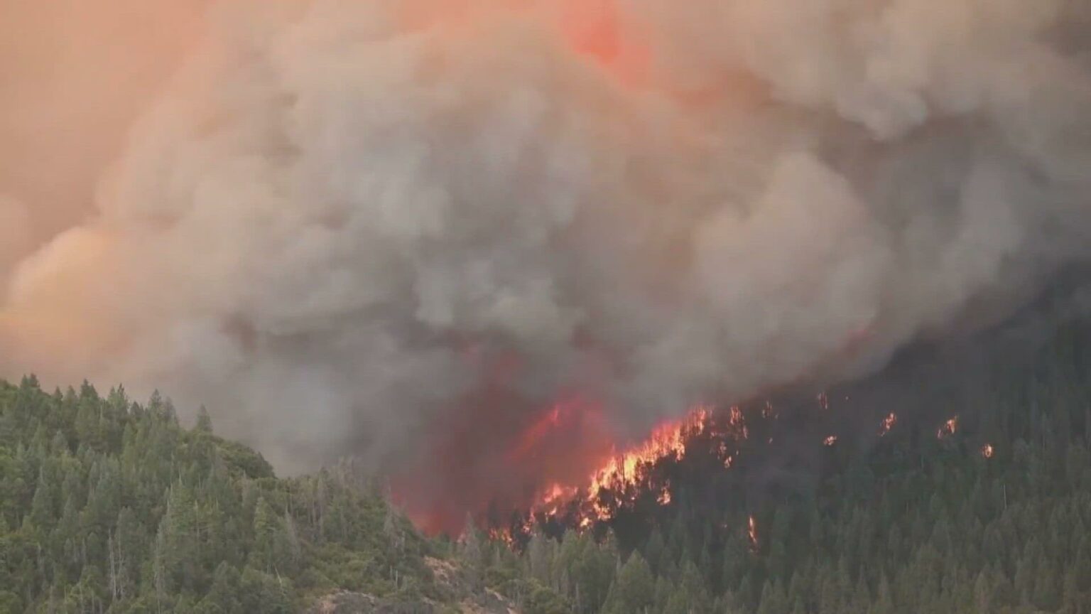 Crews battle wildfires across the US West and fight to hold containment lines